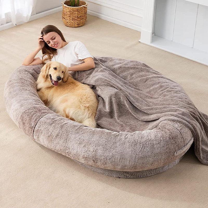 Pet owner relaxing on Human Haven Pet Lounger with dog